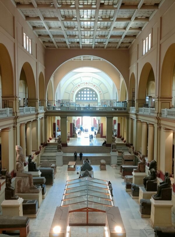 Wide view of the Egyptian Museum's main hall showcasing ancient sculptures and architecture.